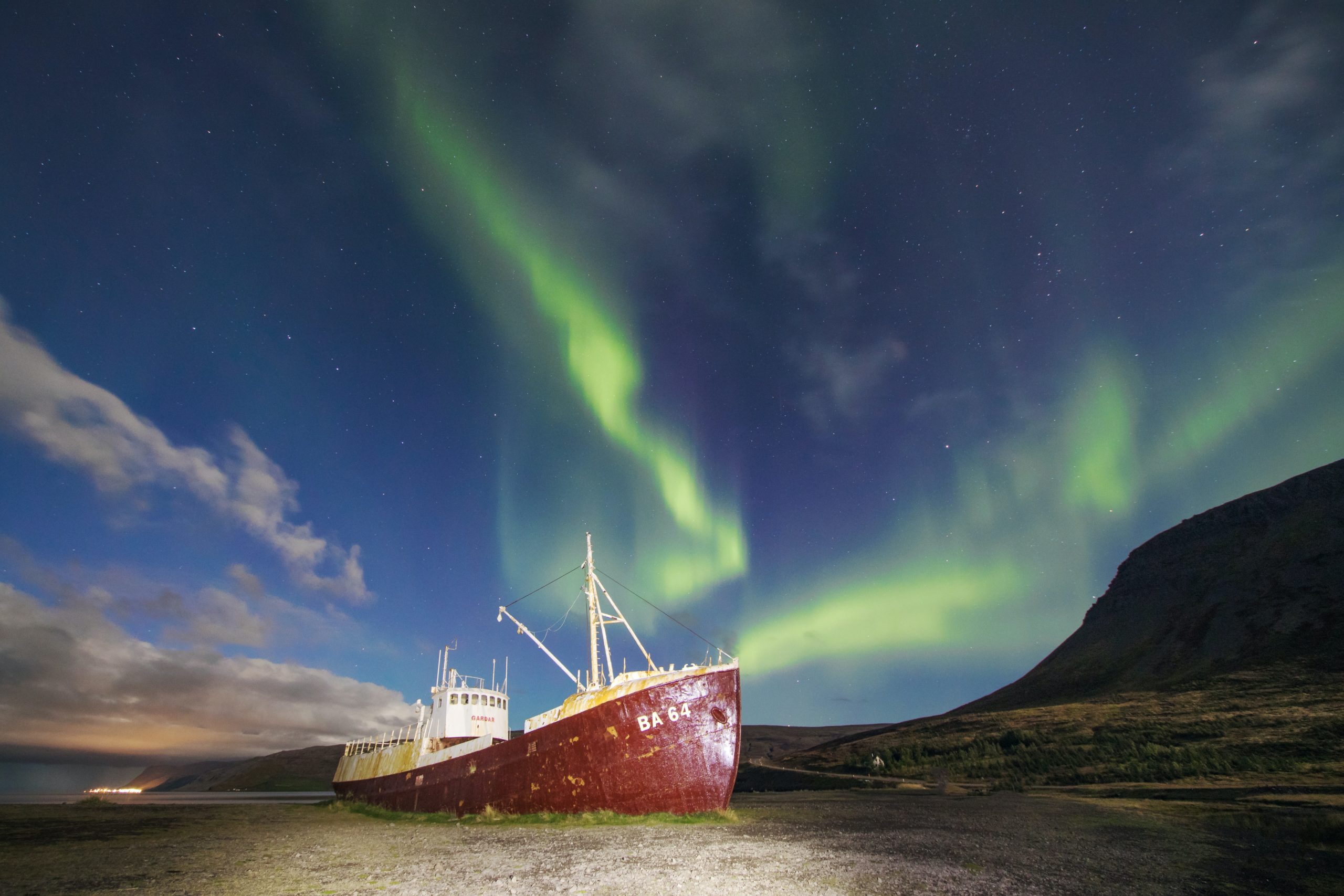 Northern Lights above a boat in Iceland