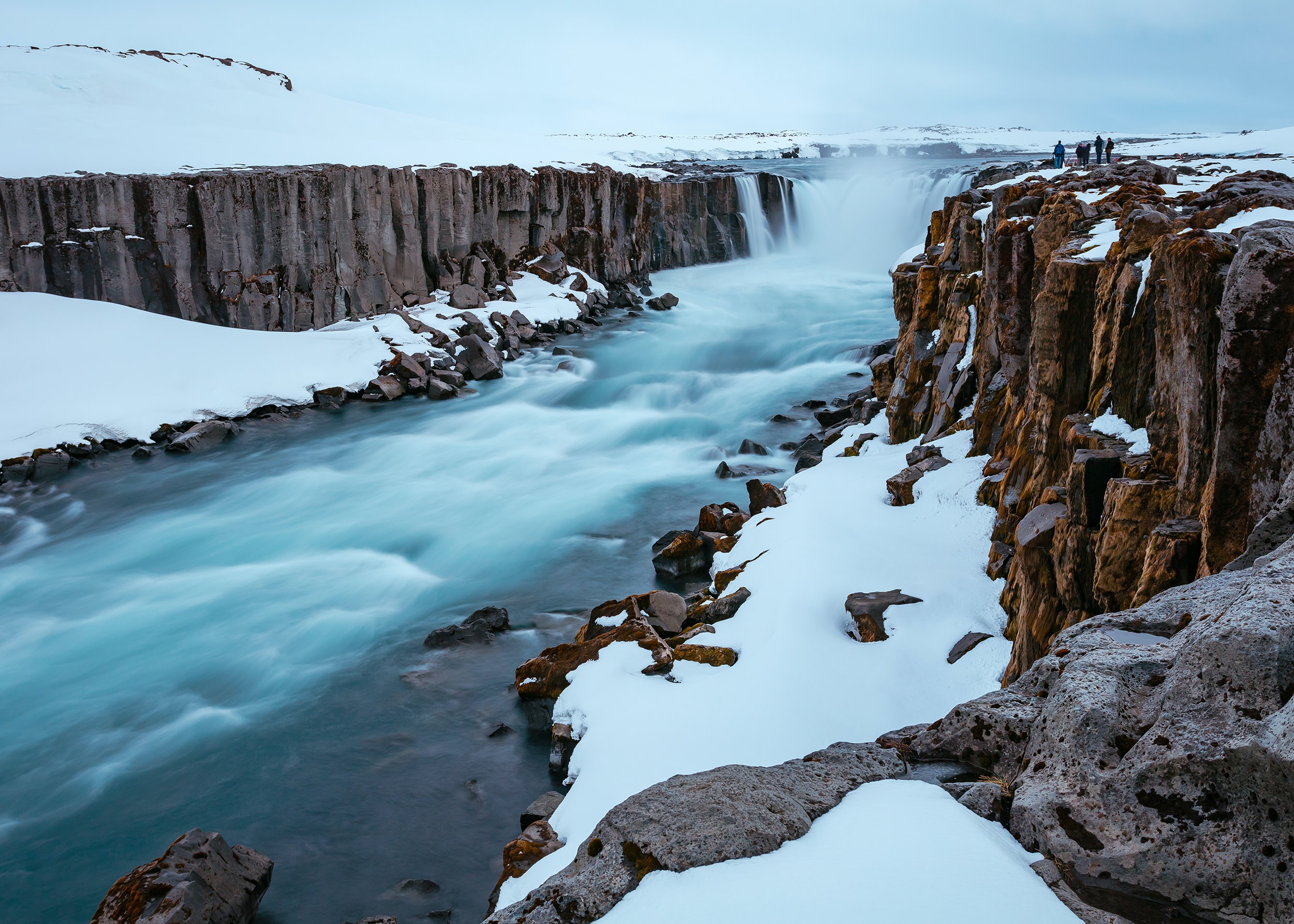 A river runs through a wintry valley in Iceland