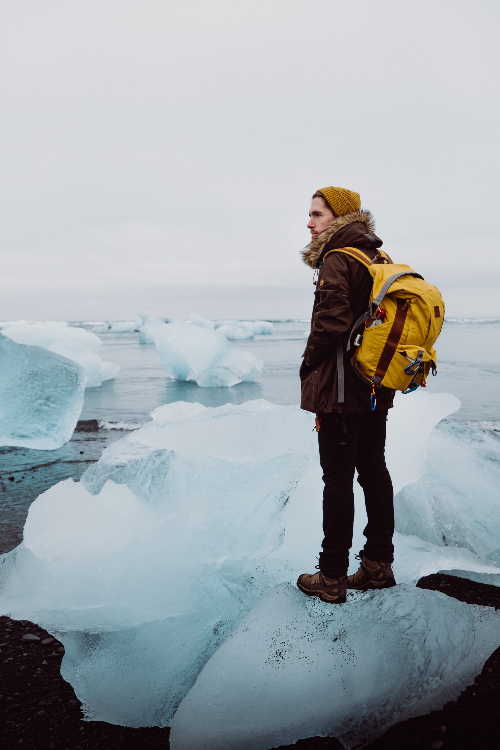 A man stands on an iceberg at Jökulsárlón